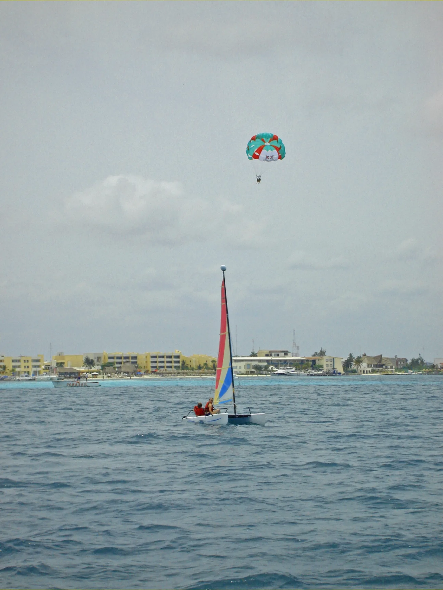 Catamaran under full sail with white decks on a private snorkeling charter like the Cancun half day trips