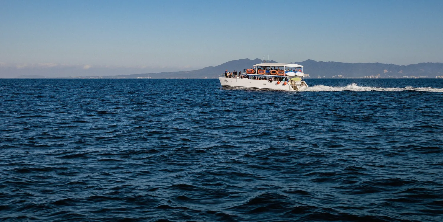 Tour catamaran moored in blue water on a private half day snorkeling charter in Mexico